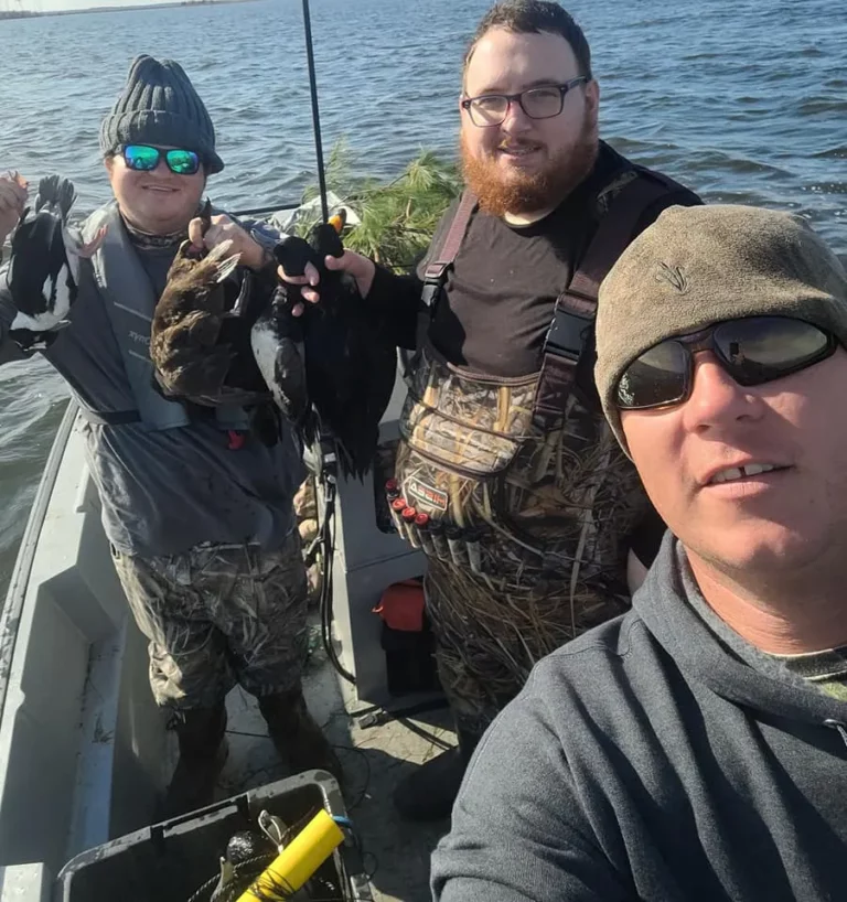 Group of hunters with a diver duck hunting harvest